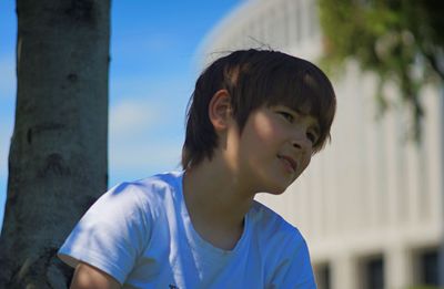Portrait of teenage boy looking away outdoors