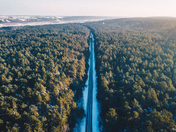 High angle view of river by trees against sky