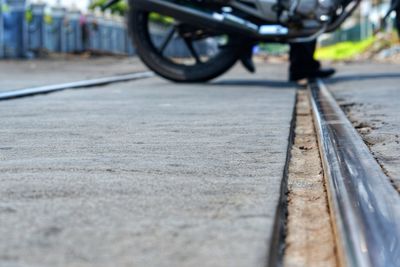 Close-up of bicycle on railroad track