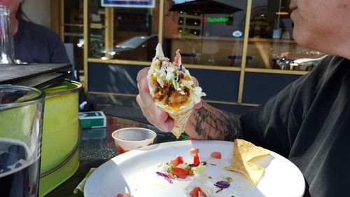 Close-up of people eating food in restaurant