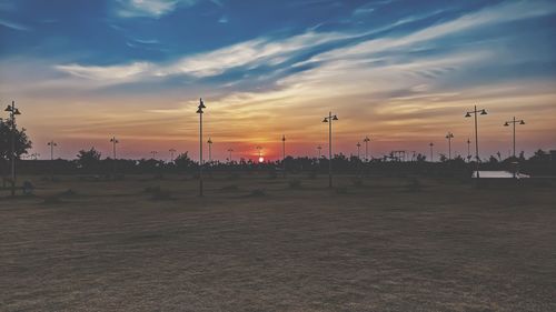 Scenic view of street against sky during sunset