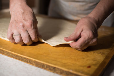 Close-up of man preparing food on table