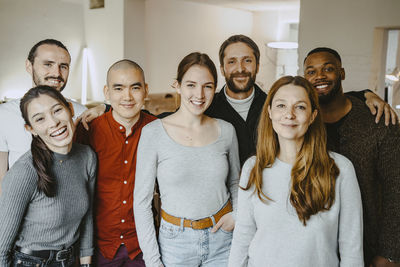 Portrait of happy multiracial male and female hackers in startup company