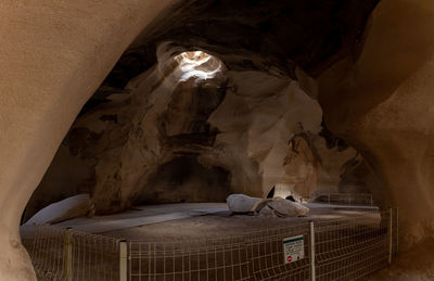 Low angle view of illuminated building in cave