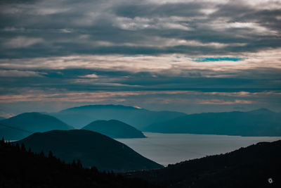 Scenic view of silhouette mountains against sky at sunset