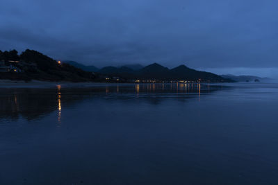 Scenic view of lake against blue sky at dusk