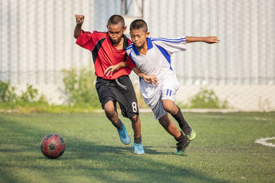 Full length of man playing soccer on field