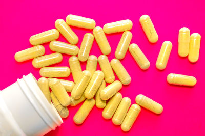 Close-up of pills spilling from bottle