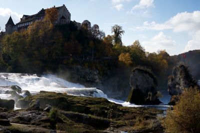 Scenic view of waterfall against sky