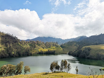 Scenic view of lake and mountains against sky