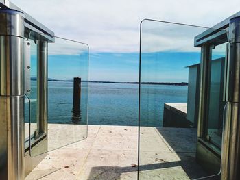 Scenic view of sea against sky seen through window