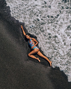 High angle view of person lying on sand at beach