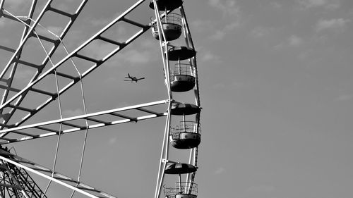 Low angle view of ferris wheel against sky