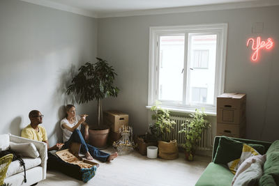 Couple sitting on floor and having pizza