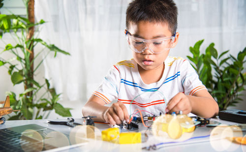 Portrait of boy eating food at home