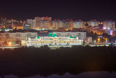 Illuminated buildings against sky at night