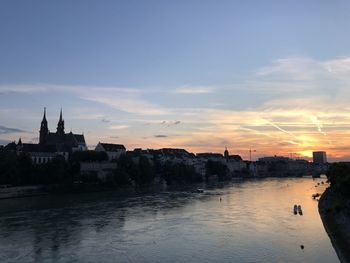 Buildings in city at sunset