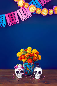 Close-up of multi colored flower vase against black background