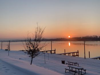 Scenic view of snow covered landscape against sky during sunset