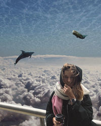 Young woman with horse in water against sky