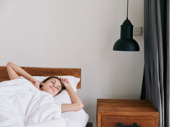 Young woman sleeping on bed at home