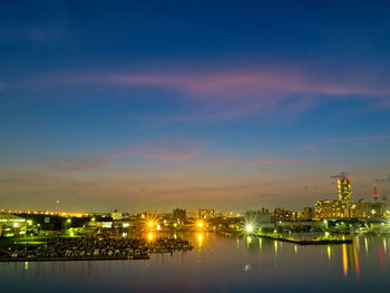 Illuminated buildings against sky at night