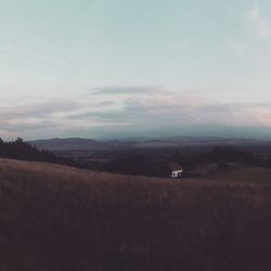 Scenic view of field against sky at sunset