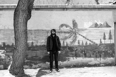 Rear view of man standing by tree