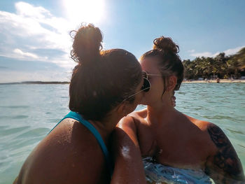 Close-up of couple kissing in sea