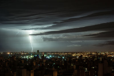 Aerial view of illuminated cityscape against sky at night