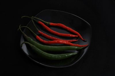 Close-up of red chili pepper against black background