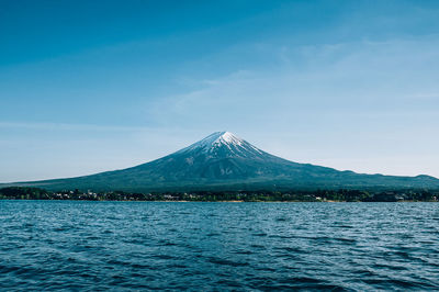 Scenic view of snowcapped mountains against blue sky