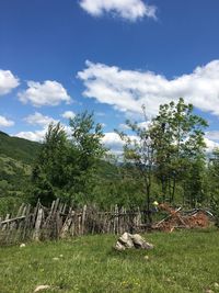 Scenic view of grassy field against cloudy sky