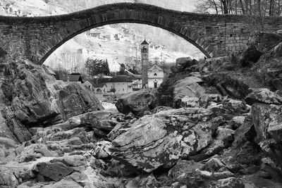 Arch bridge over river amidst trees