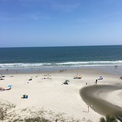 Scenic view of beach against blue sky