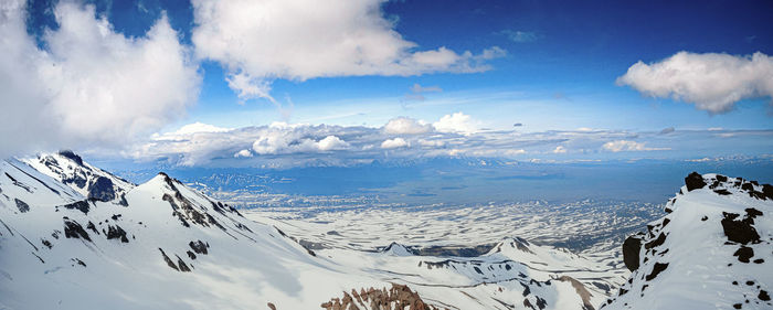 Scenic view of snow covered mountains against sky