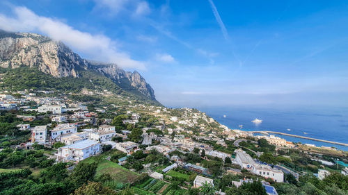 High angle view of townscape by sea against sky