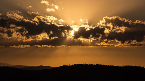 Scenic view of mountains against cloudy sky