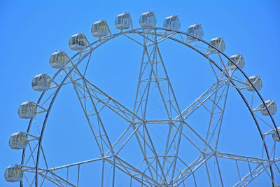 Low angle view of communications tower against clear blue sky