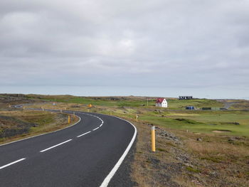 Road passing through landscape against sky