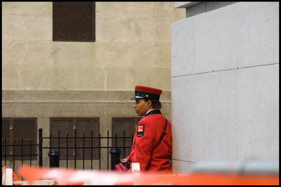 Man standing against built structure