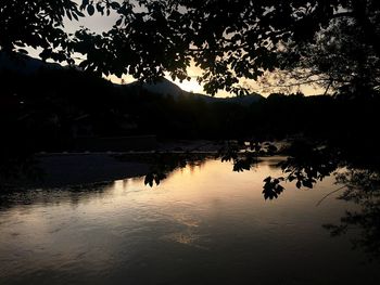 Scenic view of lake against sky at sunset