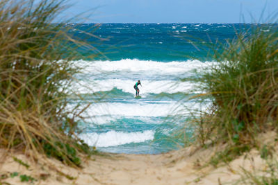 Man on beach against sky