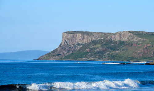 Scenic view of sea against clear blue sky