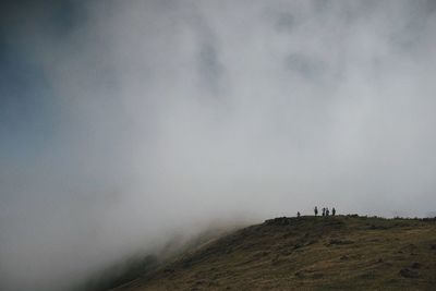 Man on landscape against sky