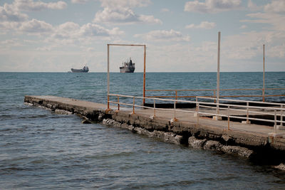 Pier over sea against sky