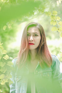 Portrait of beautiful young woman in plant