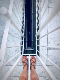 Low section of woman standing on staircase