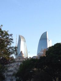 Low angle view of buildings against clear blue sky