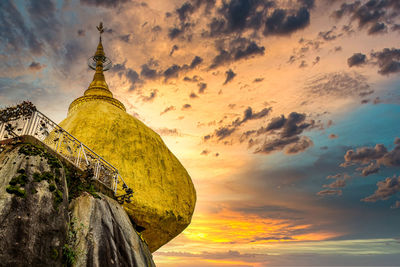 Low angle view of temple building against sky during sunset